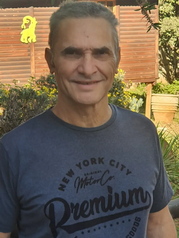 “Jimmy, next to the garden cabin I rebuilt — a symbol of the journey back.”