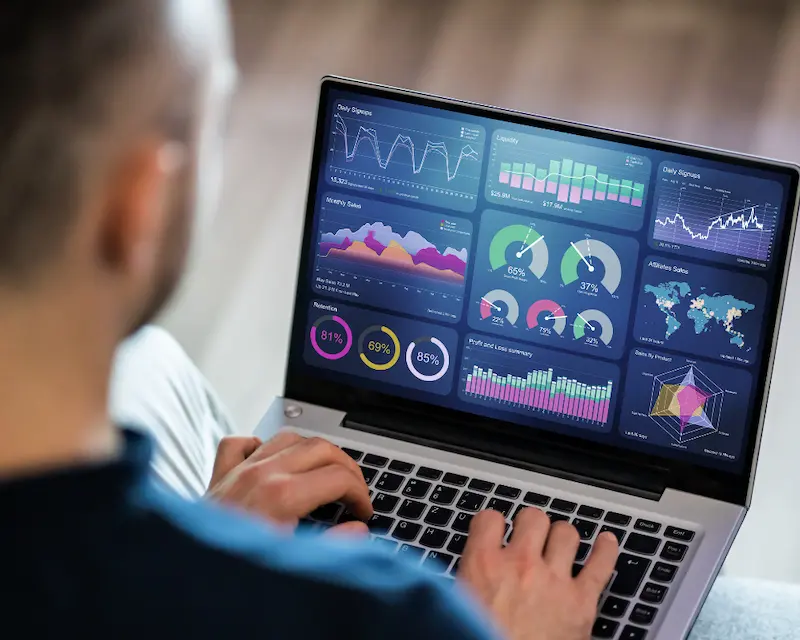 "A man reviewing digital analytics and performance dashboards on his laptop - showing how digital tools for beginner entrepreneurs can track growth and simplify progress."